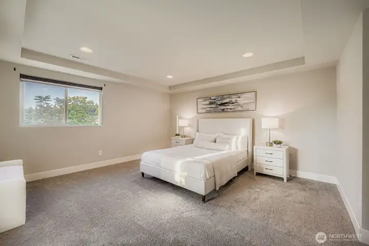 Primary bedroom with en suite bath and walk-in closet.