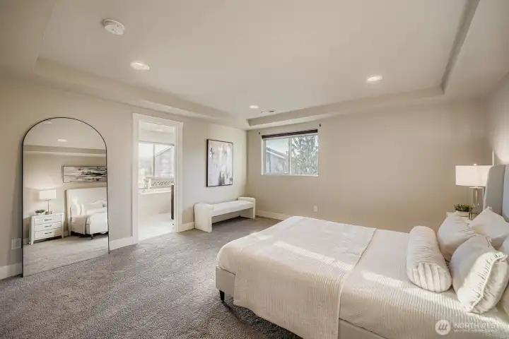 Primary bedroom with en suite bath and walk-in closet.