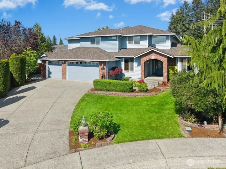 Timeless curb appeal with mature landscaping & inviting front entry.