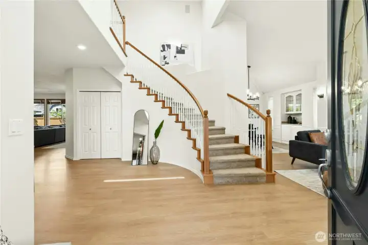 Grand entry featuring soaring ceilings & sweeping staircase