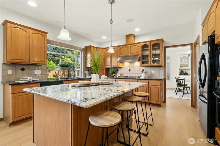Chef’s kitchen with granite counters & abundant prep space