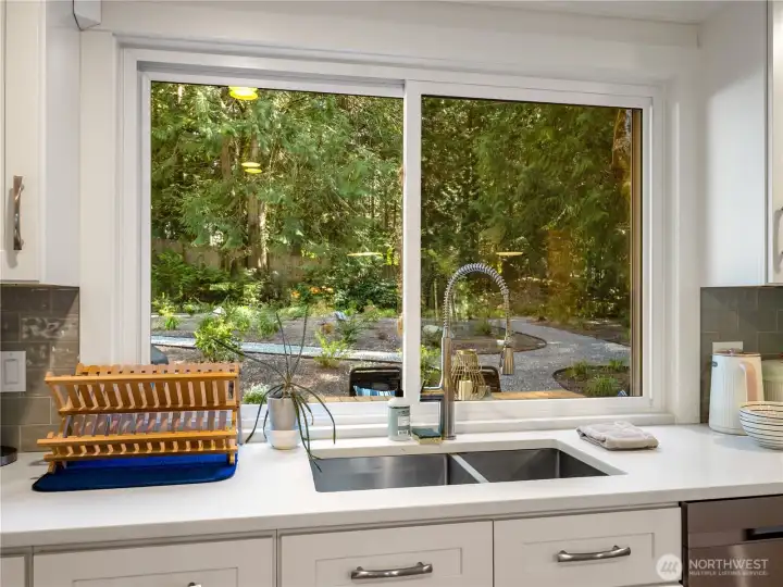 Enjoy the views of the spacious gardens and greenbelt which provides privacy & a tranquil backdrop year-round.