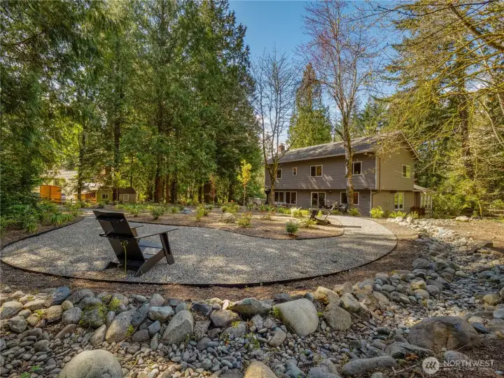 The back deck is made for entertaining & relaxing alike, surrounded by mature evergreens, native plantings, & the peaceful sounds of nature. This upper level would make a fantastic place to unwind and enjoy the great outdoors.
