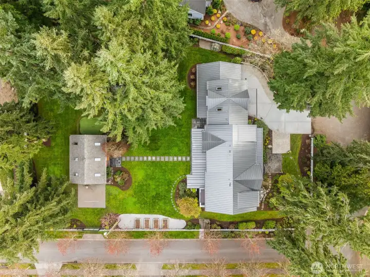 Meticulously Landscaped 3/4 acre lot with groves of trees, vibrant flowering and fragrant plantings.