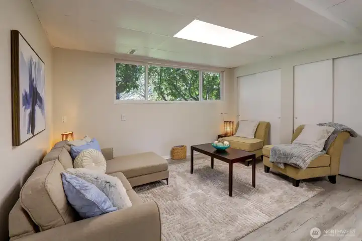 Downstairs rec room.  Look behind doors in background for big multi-purpose storage room.