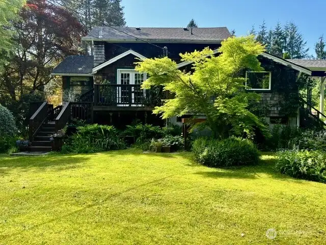West side of the house showing ironwood deck that wraps around to the front door from the living room.