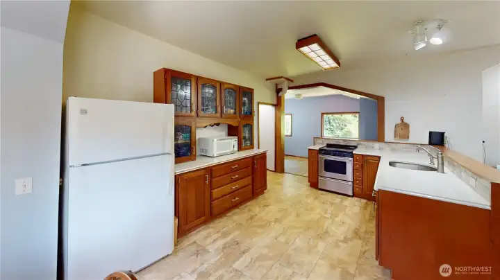 Kitchen showing decorative glass door hutch that can stay if buyers want.