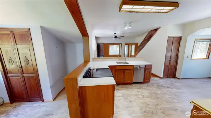 Looking into the kitchen, living room and small nook.