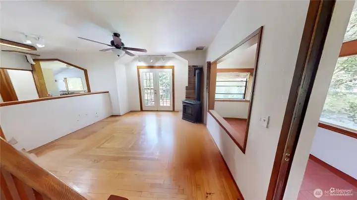 Beautiful hardwood floors looking at the french doors that open to the ironwood deck.