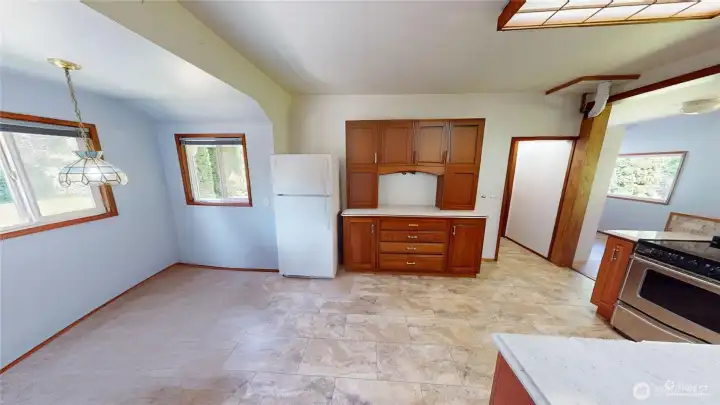 From the living room looking at the kitchen. and dining room.