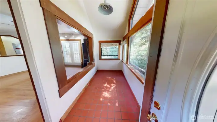 Enclosed foyer with tile floor.