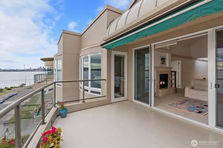 The expansive view deck can be accessed through double sliding doors from both the living room and the primary suite, creating a seamless indoor-outdoor living experience. A remote-controlled power awning provides the perfect amount of shade and comfort on sunny days.