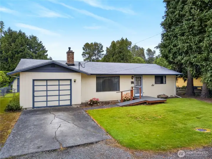 Charming single-level home with a spacious yard, attached garage, and inviting ramp entry, nestled on a quiet lot surrounded by mature trees and established landscaping. Charming single-level home with a spacious yard, attached garage, and inviting ramp entry, nestled on a quiet lot surrounded by mature trees and established landscaping.