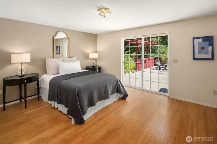 Primary bedroom w/sliding glass doors to large deck. Primary bedroom w/sliding glass doors to large deck.