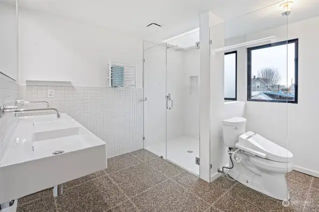 Euro style spa bathroom with terrazzo 24x24 heated tile flooring, oversized walk in shower and heated towel rack. This bathroom also has a great sized closet for storage.