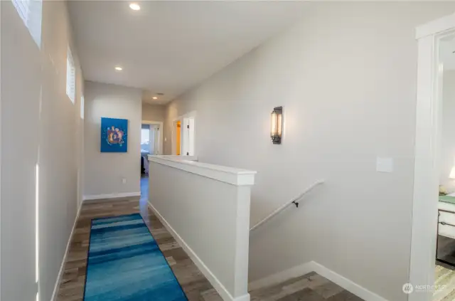 The sleeping quarters are located upstairs and all set up for a peaceful night’s sleep. Pictured on the right is the door to the Queen-sized bedroom. The twin bedroom is located up the hall to the right and the King-size suite is located at the end of the hall in the back of the home.