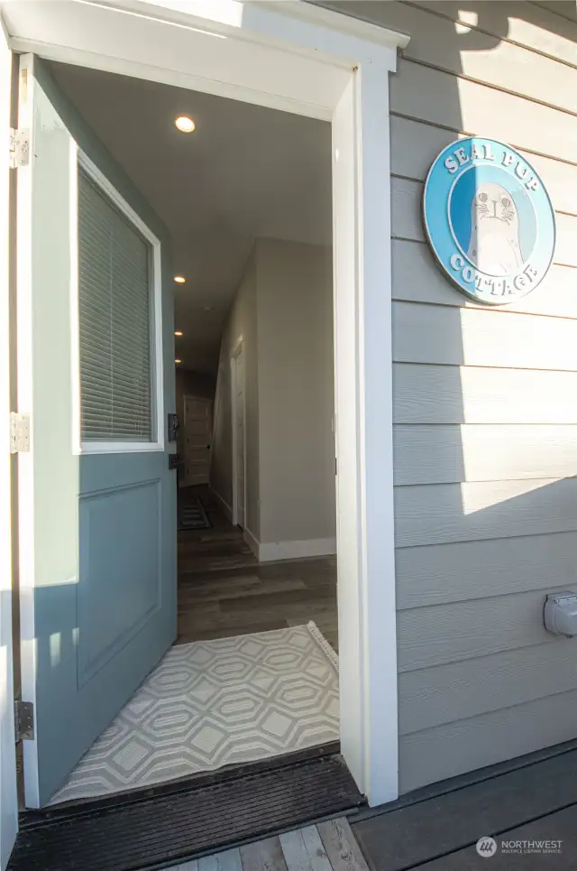 The main floor features the game room or "Seal Pup Den" which is located in the garage, plus a half-bath, the great room with a propane gas fireplace, dining area with door leading to the covered deck and the open kitchen with a large eating bar.