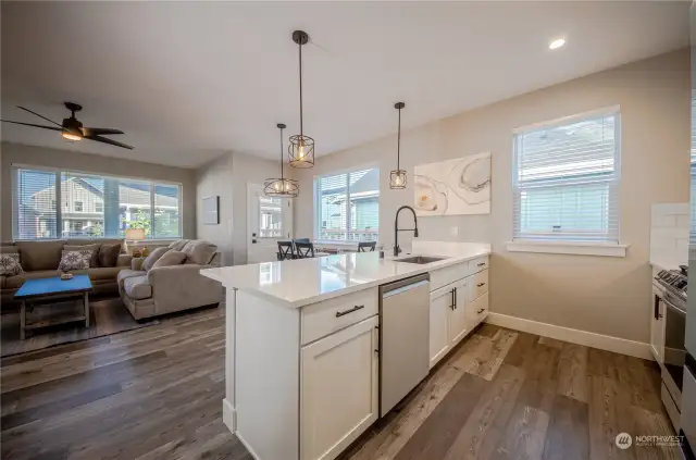 The two-story floor plan is designed so that the living area is situated towards the back of the home and looks out over the attractively landscaped common area between the homes rather than the road.