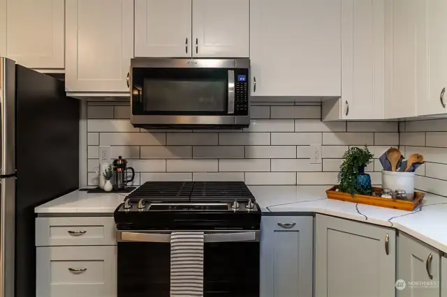 Quartz counters with custom tile backsplash