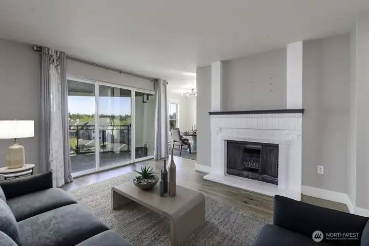 Living room w/cozy fireplace, and open concept living. Virtually staged.