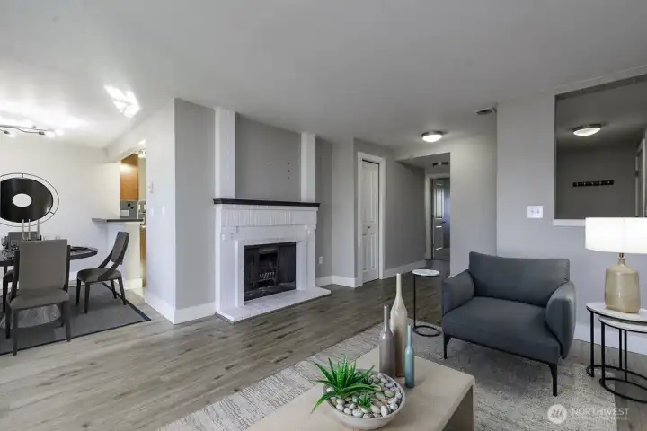 Open concept living freely flows from living room to dining and kitchen Virtually staged.