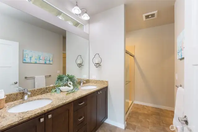 Primary bath with lovely tile and great natural light through the transom window.