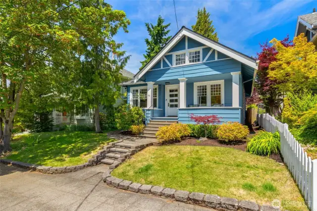 The lovely landscaped front yard, complete with white picket fence.