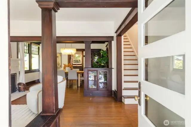 Enter into this beautiful   living room with hardwoods, high ceilings, and original columns, beams and built-ins with leaded glass cabinetry.