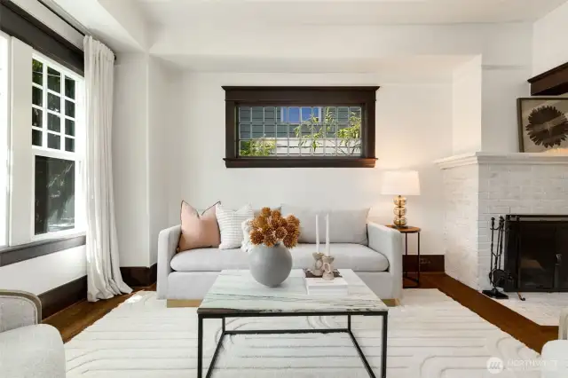 The living room gets amazing natural light through the beautiful mullioned windows.  It is spacious enough for a couple of sofas if desired, or many options for arrangement of furniture.