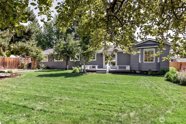 Large rear yard with mature landscaping.