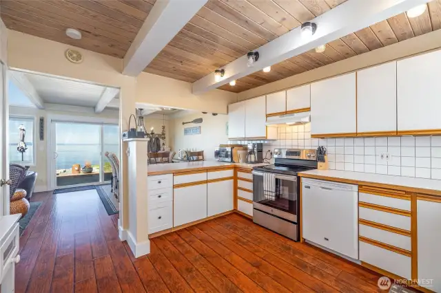 Kitchen opens to dining room with views.