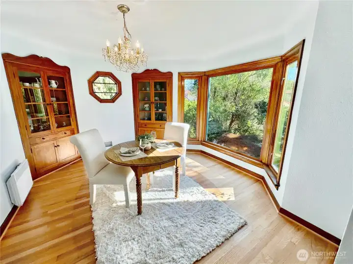Lovely formal dining room features rich, oak floors, octagon window flanked by the original Mahogany built-in hutches and south facing bay windows.