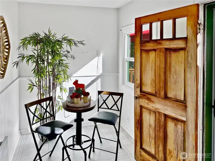 Sunny eating nook or cozy office space with access to the side sun deck and lower slate patio.