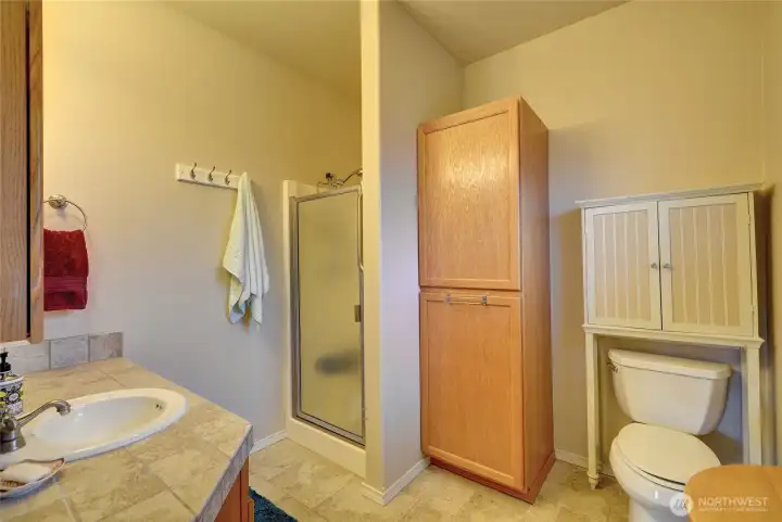 The attached primary bathroom has lots of countertops and storage.