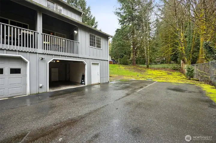 Tandem garage located on back side. On the right of it is extra storage. In the back is even more extra storage. And enjoy extra parking along side it.