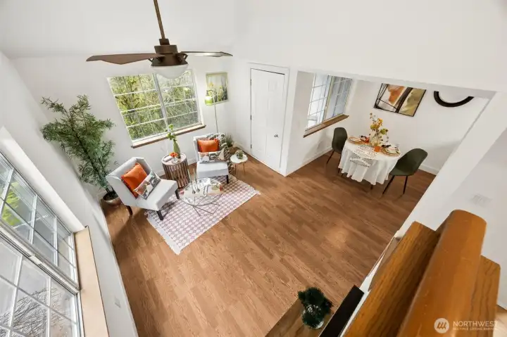 Vaulted ceilings show off the well lit living room of this 2 story condo.