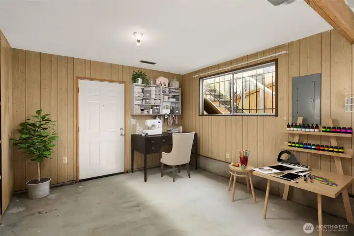 Lower-level entry off the carport offers a flexible bonus space—perfect for a crafting studio, hobby zone, or everyday activity room tailored to your needs.