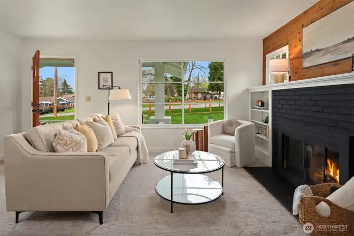 Inviting and full of character, the living room is anchored by a cozy fireplace, substantial mantle, and built-ins that make the space feel both comfortable and timeless.