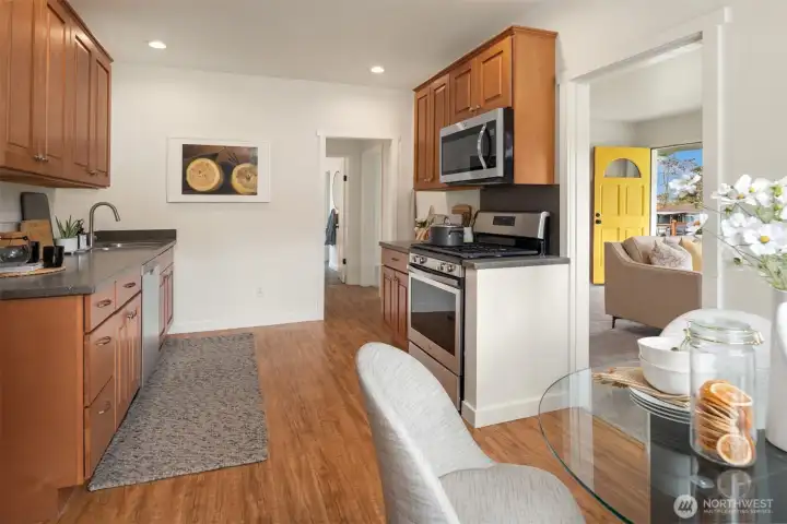 The updated kitchen offers ample cabinetry, stainless steel appliances, a gas range, and laminate flooring for durable everyday function and easy care.