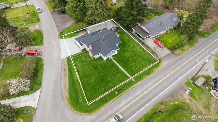 From above, the scale of this approximately 9,600 sq. ft. fully fenced corner lot really shines — large, level, usable, and full of opportunity.