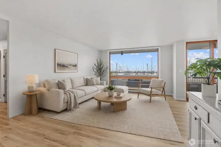 Expansive, light-filled living space anchored by floor-to-ceiling windows with panoramic views of Shilshole Marina and Puget Sound.   [Photo has been virtually staged.]