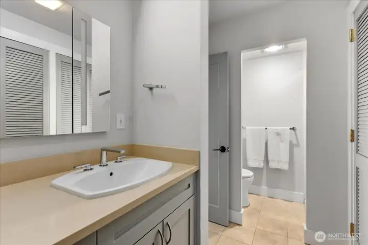 Elegant baths featuring quartz countertops throughout and rich fir millwork adds warmth and texture.