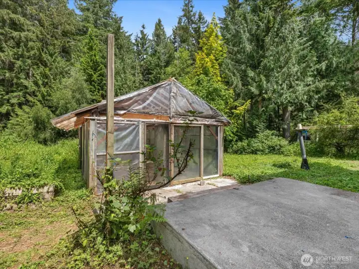The greenhouse outside is large enough for all your plants to thrive.  Also dont miss the wood stove inside.