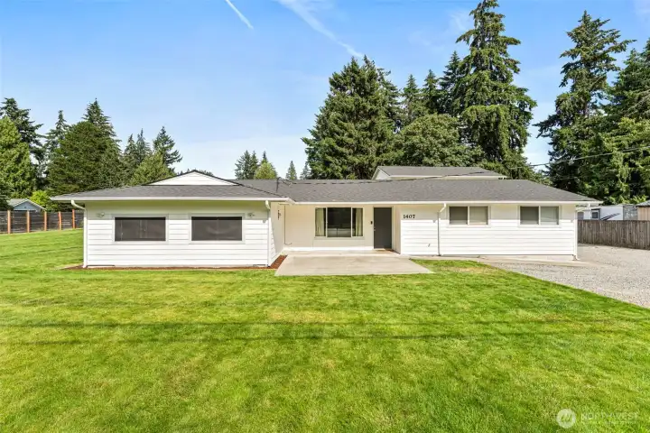 Main home with large front yard and patio.