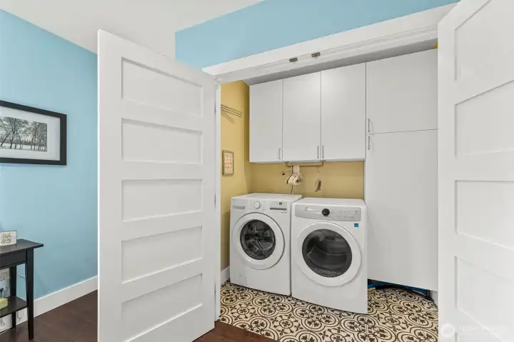 Laundry room with linen closet and storage.