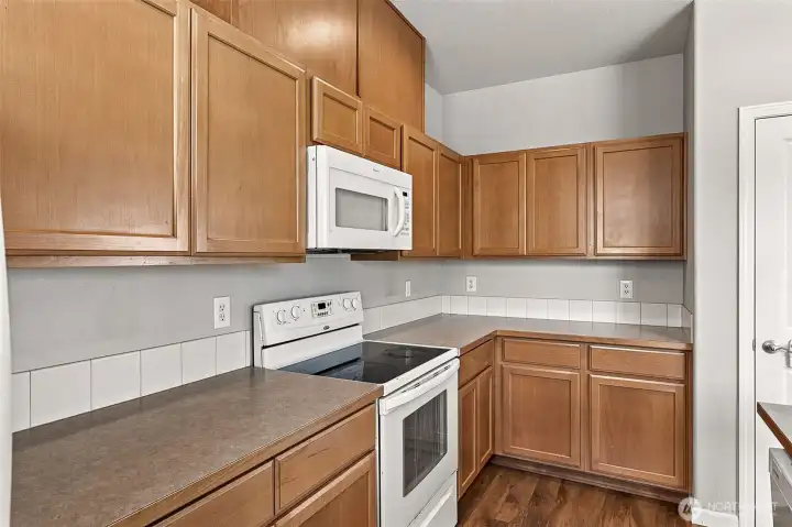 Spacious Kitchen with Plenty of Counterspace, Cabinets, and Breakfast Bar Spacious Kitchen with Plenty of Counterspace, Cabinets, and Breakfast Bar