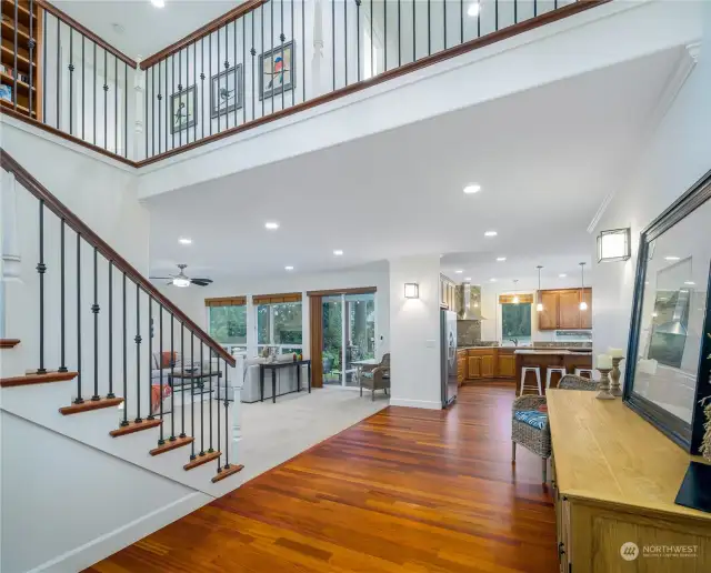 Grand entry staircase, with living area to the right and Spacious kitchen and dining to the left.