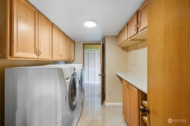 Fantastic laundry room with plenty of counterspace and cabinets.