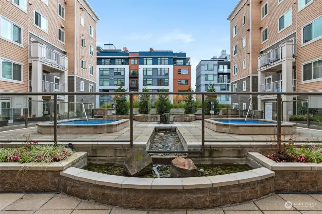 Here is the inner courtyard- accessible from 2nd floor- complete with outdoor shower, 2 jacuzzies, BBQ, water feature and lounge/dining/sunbathing areas