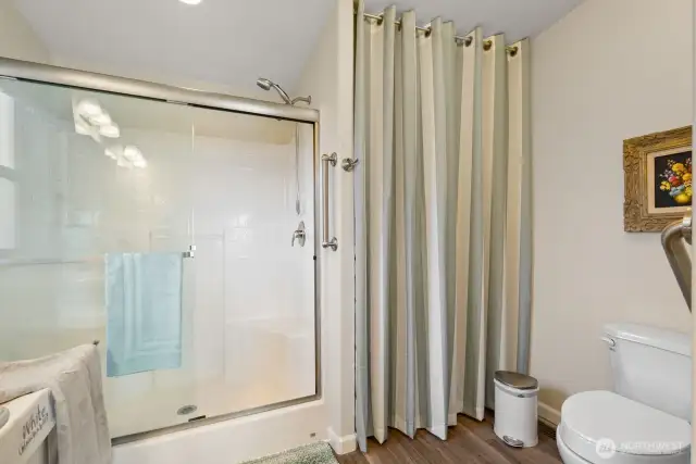 Primary bathroom with storage closet for towels and sheets